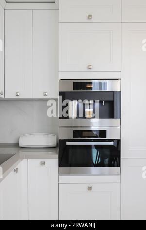 Built-in fully automatic coffee machine in kitchen furniture Stock Photo