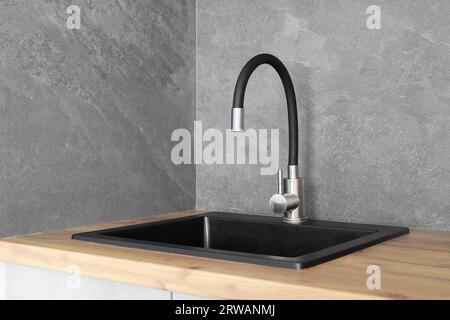 Faucet with granite sink in the kitchen interior Stock Photo