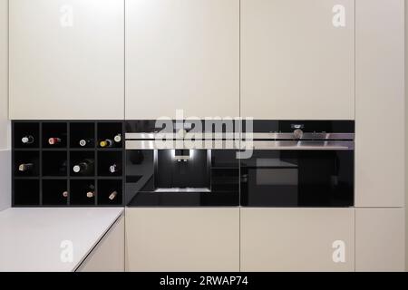 Built-in fully automatic coffee machine, electric oven in the kitchen furniture Stock Photo