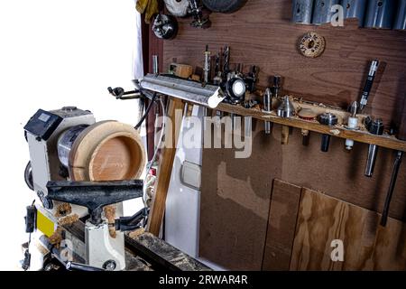 Wooden bowl during making in the lathe. White background. Stock Photo