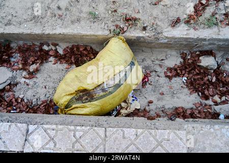 Yellow splitting bag on the ground Stock Photo