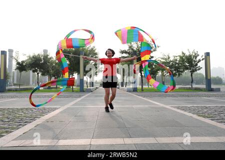 Luannan County, China - July 15, 2019: Women dancing ribbons with both hands, Luannan County, Hebei Province, China Stock Photo