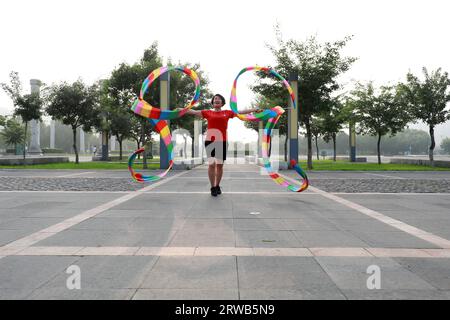 Luannan County, China - July 15, 2019: Women dancing ribbons with both hands, Luannan County, Hebei Province, China Stock Photo