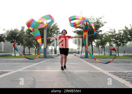 Luannan County, China - July 15, 2019: Women dancing ribbons with both hands, Luannan County, Hebei Province, China Stock Photo