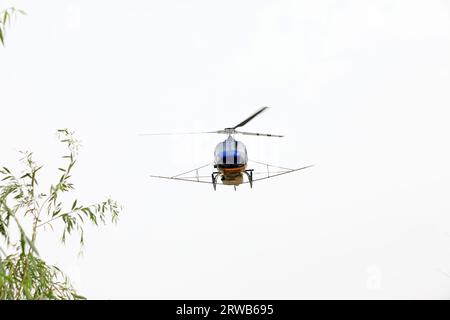 Agricultural helicopters fly in the sky Stock Photo - Alamy