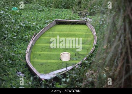 A sinking boat in the pond Stock Photo