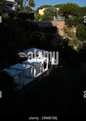 A lady in a bathrobe on a hotel blacony looking over the beautiful coastline of Platja d'Aro, in Catalonia, Spain. Stock Photo