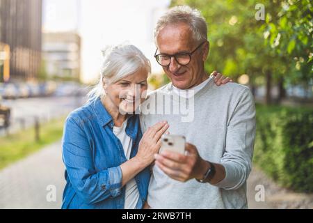 Senior couple using smartphone in the city Stock Photo