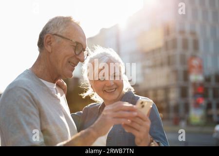Senior couple using smartphone in the city Stock Photo