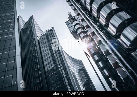 Various modern buildings in the City of London. Filtered black and white processing with slight blue tones and a sunburst. Space for text. Stock Photo