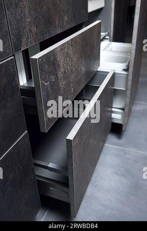 Horizontal sliding pull out drawer shelves storage in kitchen cupboard and Kitchen waste bin cabinet. Pull out kitchen drawer for waste bin separate Stock Photo