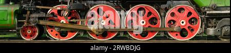 Group of red wheels and steel machinery of antique steam locomotive Stock Photo