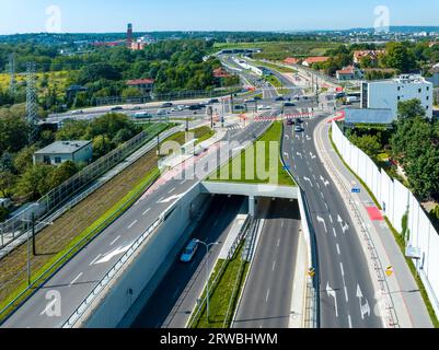 City highway in Krakow, called Trasa Lagiewnicka with multilane road with tunnels, junctions for cars and trams, bicycle lanes, walkways with zebra cr Stock Photo