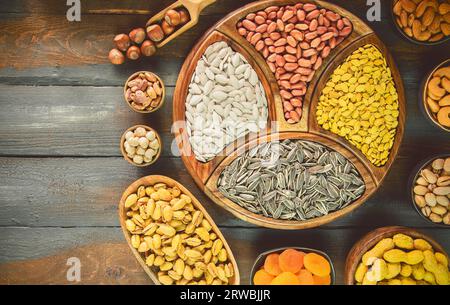 Assortment of Egyptian popular snacks sunflower seeds, watermelon seeds, pumpkin seeds and salted peanuts. Top view with close up. Stock Photo