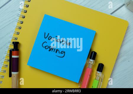 Concept of Variable Costing write on sticky notes isolated on Wooden Table. Stock Photo