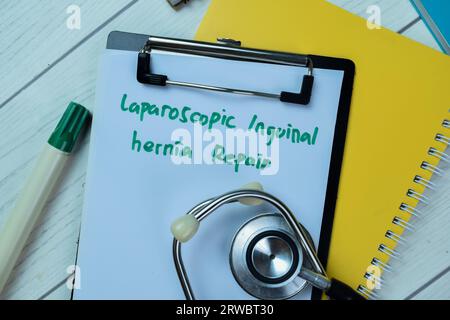 Concept of Laparoscopic Inguinal Hernia Repair write on paperwork with stethoscope isolated on Wooden Table. Stock Photo