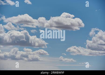 View of beautiful white cumulus clouds in blue sky with sunlight Stock Photo