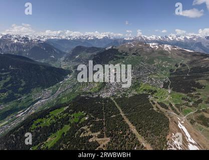 Picturesque view of mountain range with sharp peaks covered with snow and green grass on sunny spring day in the Alps Stock Photo