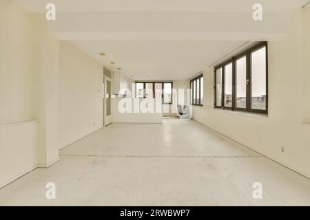 Interior of empty room with reflection of white walls and large windows on mirror in contemporary house Stock Photo