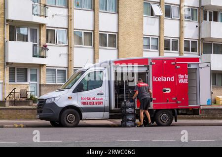 Iceland van and man delivering groceries food at Eastbourne, East Sussex, UK in September Stock Photo