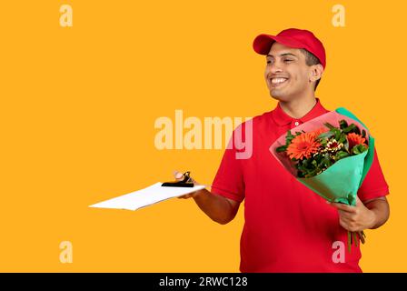 Arabic Delivery Man Delivering Fresh Flowers Bouquet Over Yellow Background Stock Photo