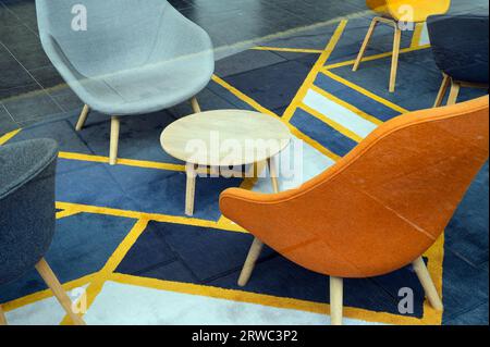Looking in through a window to an empty office with a table and chairs, UK Stock Photo