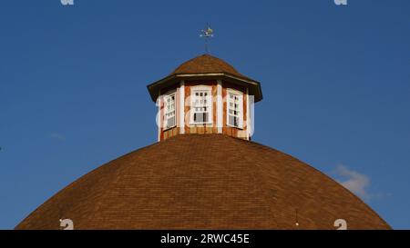 Octagonal cupola with old fashioned weather vane atop the historic Secrest 1873 Octagonal Barn. Stock Photo