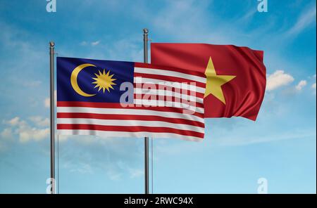 Vietnam and Malaysia flag waving together in the wind on blue sky Stock Photo