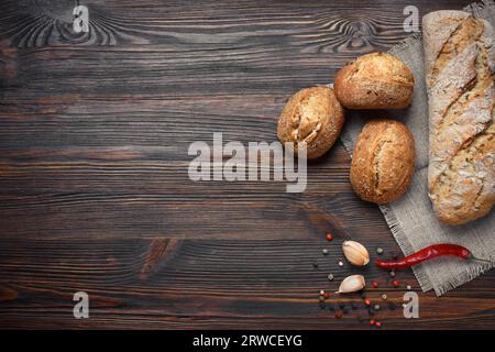 A set of bread, pepper, garlic on a brown wooden board Stock Photo