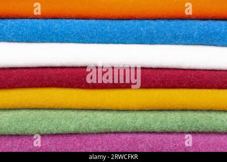 Multi-colored wool wool fabrics made of dried wool lie in a neat pile at a street fair Stock Photo
