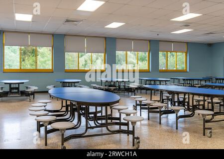 Blue folding table with attached seats in a school cafeteria. Stock Photo