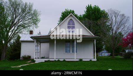 The American Gothic house, made famous by artist Grant Wood, on a softly lit spring afternoon. Stock Photo