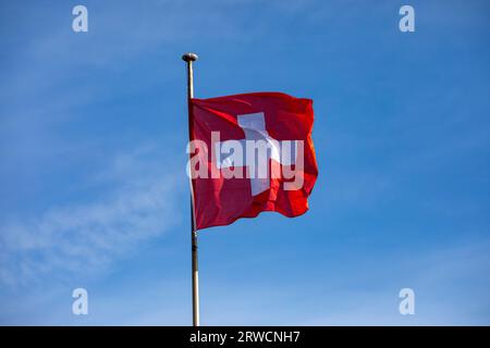 Lugano, Switzerland, 21 January 2023:  Swiss flag at Lugano on Lake Lugano, Switzerland. Stock Photo