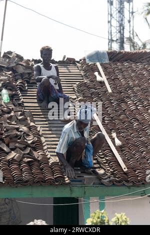 February 14, 2023, Chennai city, India: Two local men are roofing the house Stock Photo
