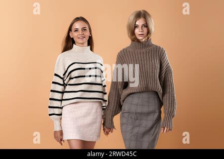 two young women friends hold each other hand Stock Photo
