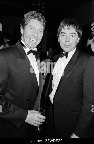 LONDON, UK. October 9, 1986: Michael Crawford & Andrew Lloyd Webber at the opening night party for “The Phanthom of the Opera” in London.  File photo © Paul Smith/Featureflash Stock Photo