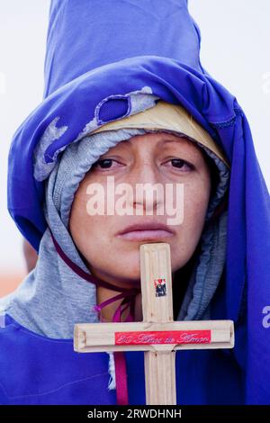 Nazarene woman with a cross of Jesus Christ in her hand and with a sad ...