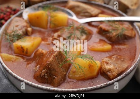 Delicious goulash in bowl on table, closeup Stock Photo