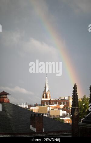 Rainbow over a Church during a Storm Stock Photo