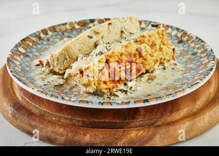 Chicken terrine with peppers, onions and herbs on plate Stock Photo