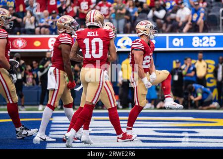 San Francisco 49ers' Christian McCaffrey, center left, and Fred Warner,  center right, stand on the field during the first half of an NCAA college  football game between Stanford and Arizona on Saturday