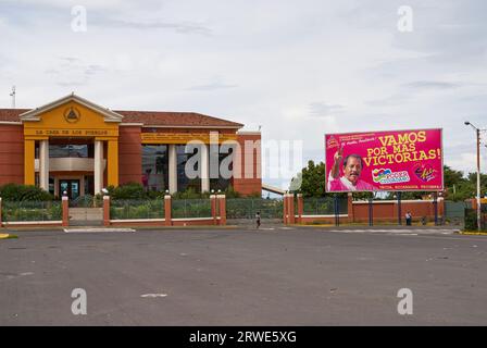 The new Casa Presidencial or Presidential house and FSLN campaign billboard in downtown Managua, Nicaragua Stock Photo