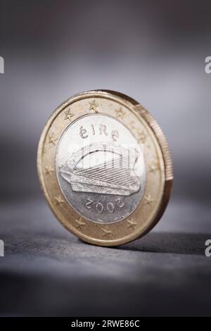 A Worn Irish Euro coin on grey. Short depth of field Stock Photo