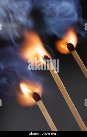 Three safety matches igniting simultaneosly Stock Photo