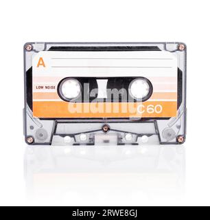 Old compact cassette audio tape isolated on white with natural shadow Stock Photo