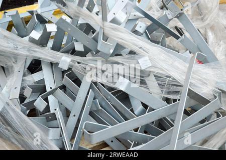 A lot of metal galvanized iron chrome construction fasteners for the facade of the building, parts, corners for repair. The background. Stock Photo