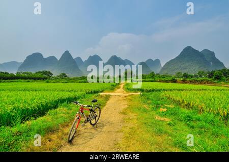 Biking on Beautiful Li river side Karst mountain landscape in Yangshuo Guilin, China Stock Photo
