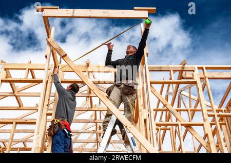 Tradesmen taking measurements in building a timber framed house in South Australia Stock Photo