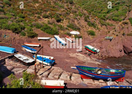 The natural harbour Porto Ferro with its fishing boats in the southwest of Sardinia Stock Photo