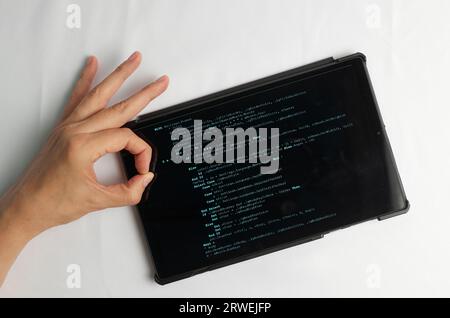 Programming and coding concept. Code generation: Fingers click to insert a new line in the code Stock Photo